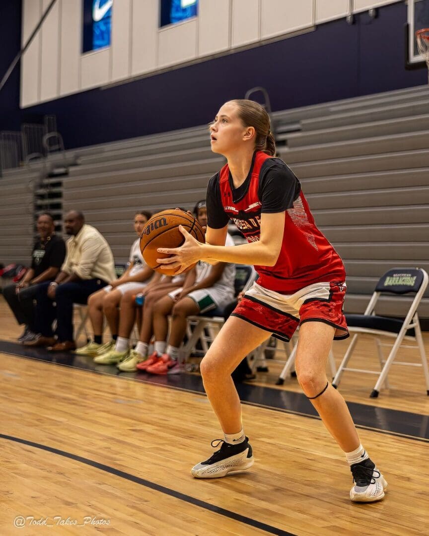 Young basketball player prepares to shoot during a game.