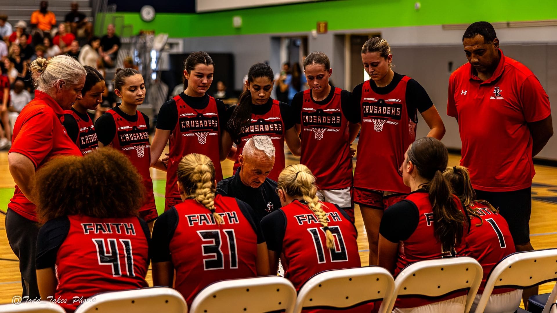 Basketball coach giving a pep talk to players during a timeout.