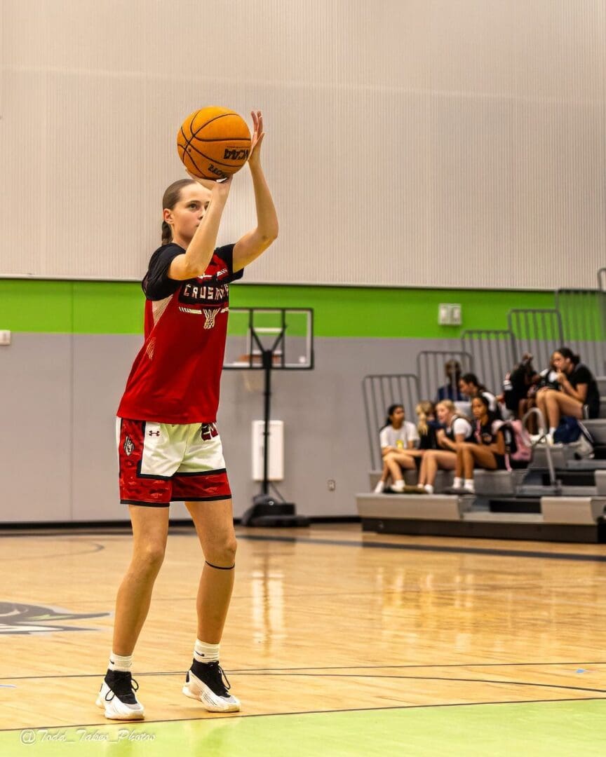 Young basketball player preparing to shoot a free throw in a gym.